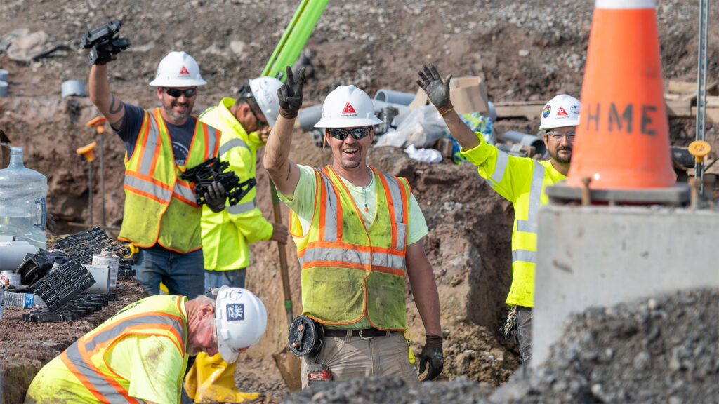 Cable team holding up a peace sign