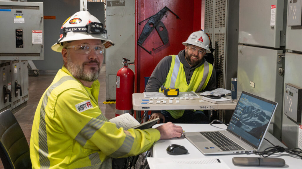 Two electricians sitting