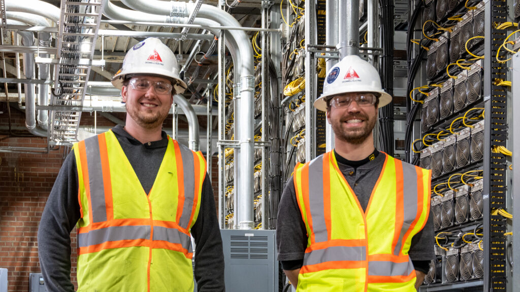 Two electricians smiling